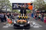 2011 Targa New Zealand winners Tony Quinn and Naomi Tillet salute the Havelock North crowd at the finish.